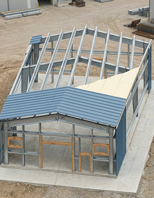 Structural steel components including columns, beams and rafter sections ready for export