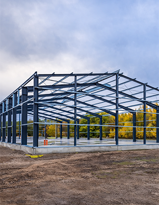 Steel-framed warehouse structure with large clear-span interior and corrugated roof sheeting